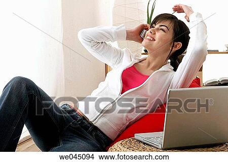 at-home, cell phone, carefree, brunette, 20's View Large Photo Image Picture - at-home, cell phone, carefree, brunette, 20's. Fotosearch