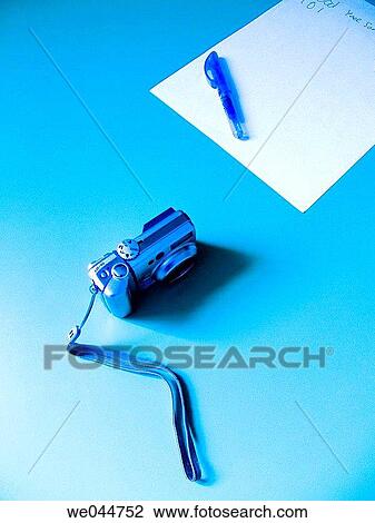 Stock Image - Ball-point pen, blue, blue-toned, camera, concept. Fotosearch