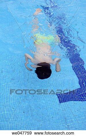 Stock Photo - Boy in swimming pool. Fotosearch