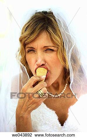 Bride eating ice cream cone with eyes half open View Large Photo Image Stock Image - Bride eating ice cream cone with eyes half open. Fotosearch