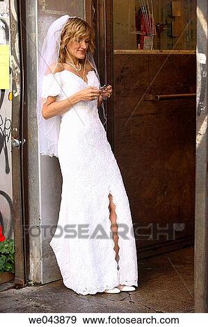 Stock Photo - Bride in entrance of shop. Fotosearch