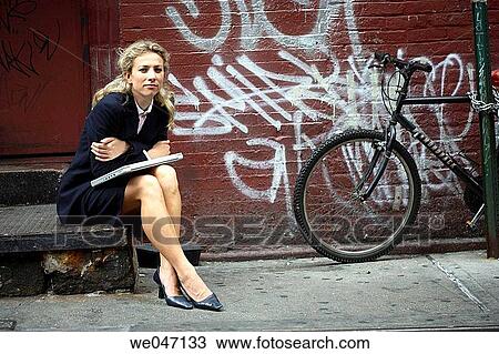 Business woman leaning on laptop outside View Large Photo Image Stock Image - Business woman leaning on laptop outside. Fotosearch