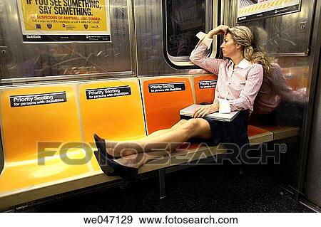 Business woman with laptop with legs across subway seats View Large Photo Image Stock Photo - Business woman with laptop with legs across subway seats. Fotosearch