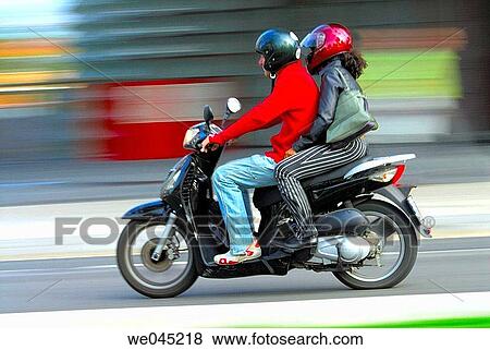 Couple on a bike. Barcelona. Spain. View Large Photo Image Stock Photo - Couple on a bike. Barcelona. Spain.. Fotosearch