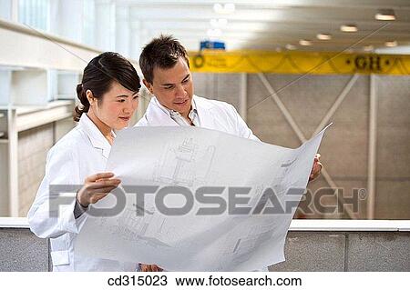Fatronik Research Centre, San Sebastian Technological Park, Donostia, Gipuzkoa, Basque Country. Technicians looking at blueprints View Large Photo Image Stock Image - Fatronik Research Centre, San Sebastian Technological Park, Donostia, Gipuzkoa, Basque Country. Technicians looking at blueprints. Fotosearch