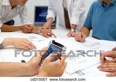 Stock Photo - Fatronik Research Centre, San Sebastian Technological Park, Donostia, Gipuzkoa, Basque Country. Fatronik Research Centre, San Sebastian Technological Park, Donostia, Gipuzkoa, Basque Country. Businesspeople and technicians looking at blueprints. Fotosearch