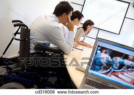 Stock Photo - Fatronik Research Centre, San Sebastian Technological Park, Donostia, Gipuzkoa, Basque Country. Handicapped man in business meeting. Fotosearch