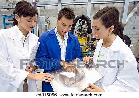 Stock Photograph - Fatronik Research Centre, San Sebastian Technological Park, Donostia, Gipuzkoa, Basque Country. Technicians checking a part manufactured y means of Incremental Sheet Forming (ISF) technology.. Fotosearch