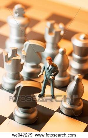 Miniature Businessman on Chess Board View Large Photo Image Stock Photo - Miniature Businessman on Chess Board. Fotosearch