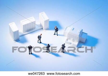 Stock Image - Miniature Businessmen and Building Models. Fotosearch