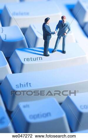 Stock Image - Miniature Businessmen on keyoard. Fotosearch