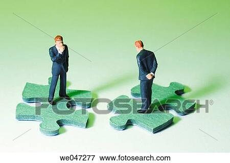 Miniature Businessmen on Puzzle Pieces View Large Photo Image Stock Photo - Miniature Businessmen on Puzzle Pieces. Fotosearch