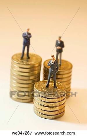 Stock Photo - Miniature Businessmen on Stacks of Coins. Fotosearch