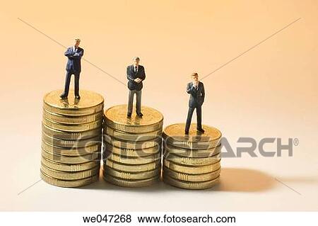Miniature Businessmen on Stacks of Coins View Large Photo Image Stock Photo - Miniature Businessmen on Stacks of Coins. Fotosearch
