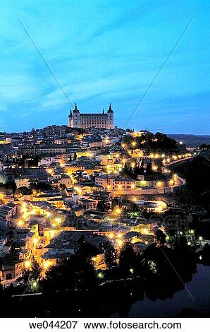 Old town on Tajo river, Alcazar and Cathedral in background. night views Toledo. Spain View Large Photo Image Stock Photo - Old town on Tajo river, Alcazar and Cathedral in background. night views Toledo. Spain. Fotosearch