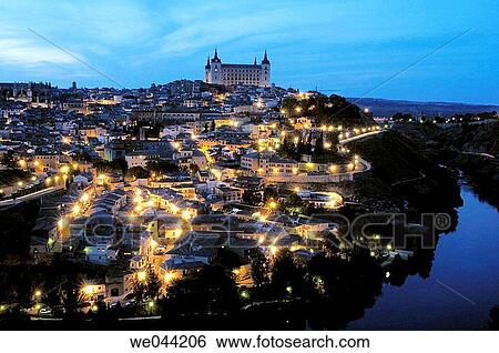 Old town on Tajo river, Alcazar and Cathedral in background. night views Toledo. Spain View Large Photo Image Stock Photograph - Old town on Tajo river, Alcazar and Cathedral in background. night views Toledo. Spain. Fotosearch