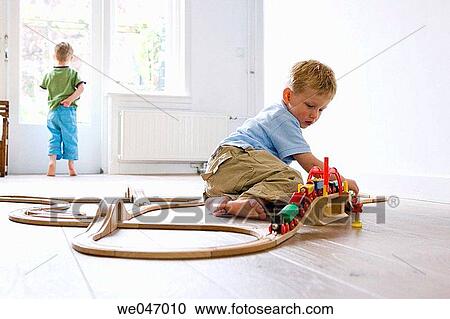 One little boy plays with a wooden train View Large Photo Image Stock Image - One little boy plays with a wooden train. Fotosearch