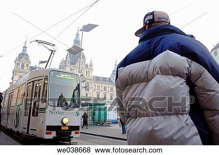 Stock Photo - People waiting for the tramway. Hauptplatz, Graz, Styria, Austria, Europe.. Fotosearch
