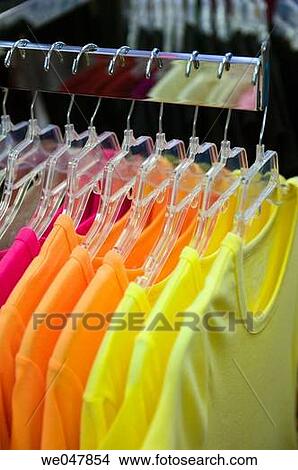T-Shirts on rack in retail clothing store. View Large Photo Image Picture - T-Shirts on rack in retail clothing store.. Fotosearch