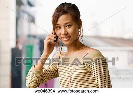 Thailand, Bangkok,? Skytrain? station? Silom?, Thai girl? Jane? making call on her mobile phone, MR_0604-0004_Jan View Large Photo Image Picture - Thailand, Bangkok,? Skytrain? station? Silom?, Thai girl? Jane? making call on her mobile phone, MR_0604-0004_Jan. Fotosearch