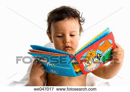 Toddler looking into a tectile book View Large Photo Image Stock Photo - Toddler looking into a tectile book. Fotosearch