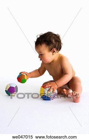 Toddler playing with three textile balls View Large Photo Image Stock Photography - Toddler playing with three textile balls. Fotosearch