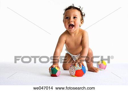 Toddler playing with two textile balls View Large Photo Image Picture - Toddler playing with two textile balls. Fotosearch