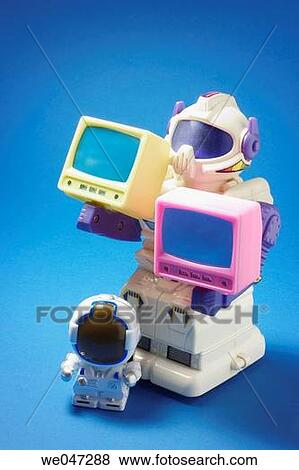 Toy robots holding miniature TVs View Large Photo Image Stock Photo - Toy robots holding miniature TVs. Fotosearch
