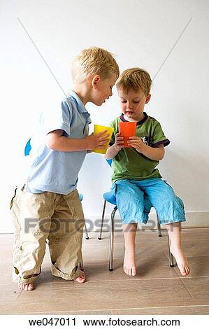 Two little boys comparing their drinks in a plastic cup View Large Photo Image Stock Image - Two little boys comparing their drinks in a plastic cup. Fotosearch