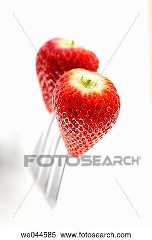 Stock Photography - Two strawberries on a fork. Fotosearch