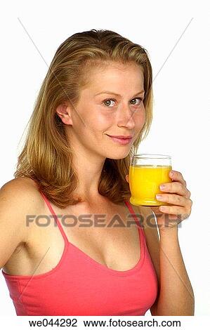 Woman drinking orange juice View Large Photo Image Stock Image - Woman drinking orange juice. Fotosearch