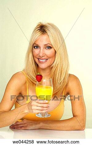 Woman drinking orange juice View Large Photo Image Stock Photo - Woman drinking orange juice. Fotosearch