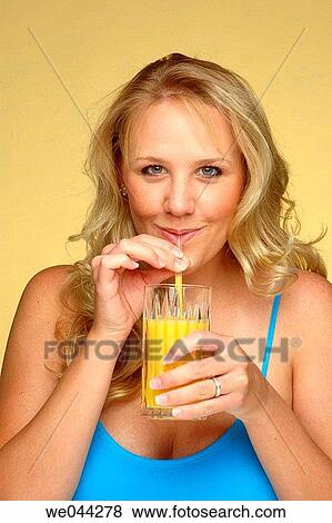 Woman drinking orange juice View Large Photo Image Stock Photo - Woman drinking orange juice. Fotosearch