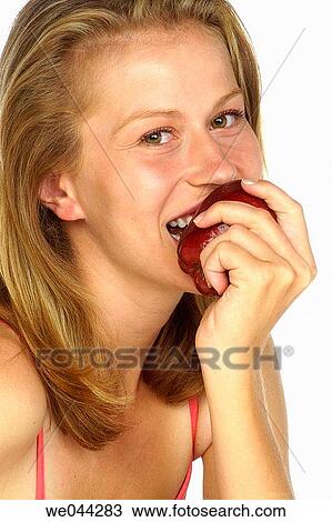 Woman eating a apple View Large Photo Image Stock Image - Woman eating a apple. Fotosearch
