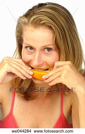Woman eating a orange View Large Photo Image Picture - Woman eating a orange. Fotosearch