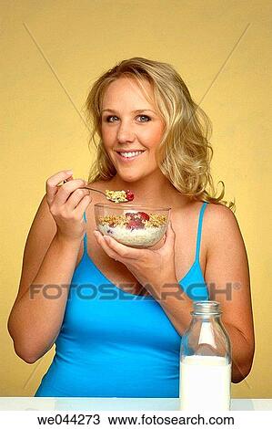 Woman eating cereal View Large Photo Image Stock Image - Woman eating cereal. Fotosearch