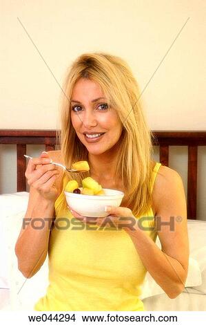 Woman eating fruit View Large Photo Image Picture - Woman eating fruit. Fotosearch