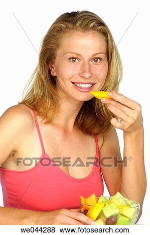 Woman eating fruit View Large Photo Image Stock Photo - Woman eating fruit. Fotosearch