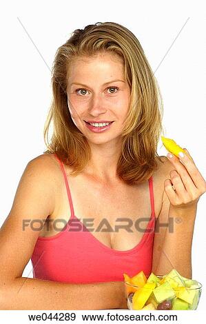 Woman eating fruit View Large Photo Image Stock Photo - Woman eating fruit. Fotosearch