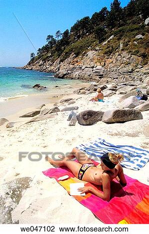Woman in topless reading a book on beach View Large Photo Image Stock Image - Woman in topless reading a book on beach. Fotosearch