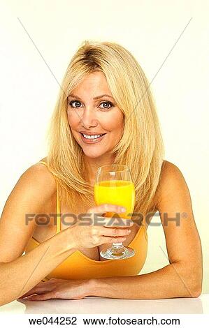 Woman with orange juice View Large Photo Image Stock Image - Woman with orange juice. Fotosearch
