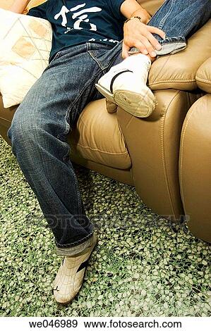 Young man leaning on coach View Large Photo Image Stock Photo - Young man leaning on coach. Fotosearch