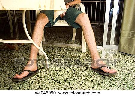 Young man sitting on a chair View Large Photo Image Stock Image - Young man sitting on a chair. Fotosearch