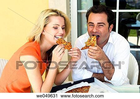 Stock Image - 30's, biting, bite, at-home, 20's. Fotosearch