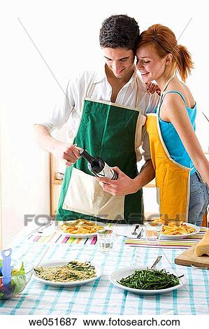 Stock Photo - amusement, Best friend, at-home, apron, 20's. Fotosearch