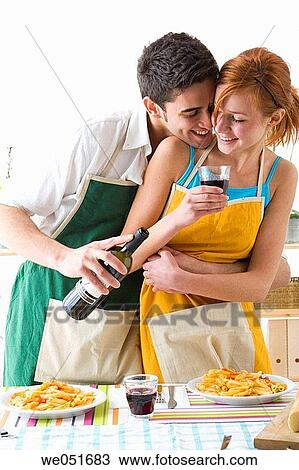 Stock Image - amusement, black hair, at-home, apron, 20's. Fotosearch
