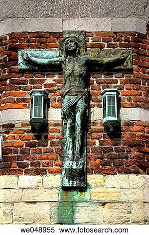 Stock Photography - an old crucificion on the wall of the old building in Gent, Belgium. Fotosearch