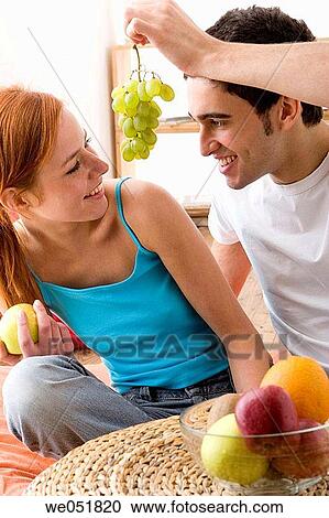 Stock Image - apple, bowl, at-home, Arms raised, 20's. Fotosearch