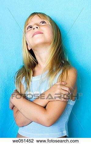 Stock Image - Arms crossed, child, blue, blond, anticipation. Fotosearch