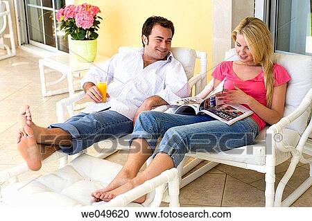 Stock Image - at-home, browsing, browse, barefoot, 30's. Fotosearch